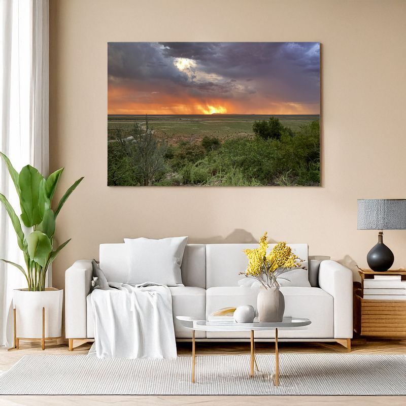 Modern living room with white sofa, canvas of Namibia sunset with dramatic fiery sky.