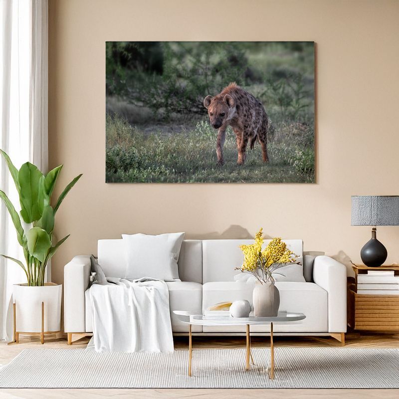 Modern living room with white sofa, canvas of a spotted hyena in green bush landscape.