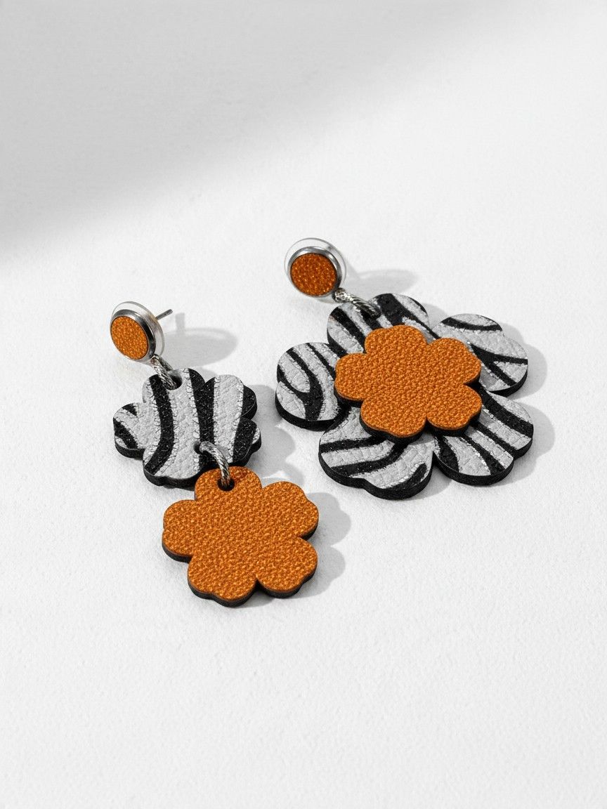 Boucles d’oreilles fleurs "pas pareilles" en cuir, noires, blanches et oranges