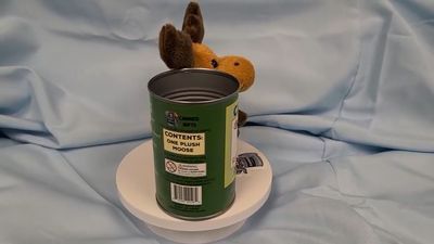 Side view of moose plush with open can