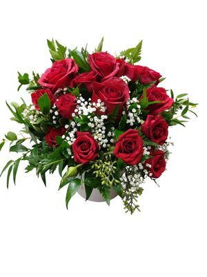 Amour flower design with red roses and greenery in a white vase
