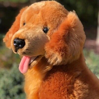 Close-up of Red Golden Retriever plush stuffed animal showing detailed fur, face, and tongue sticking out
