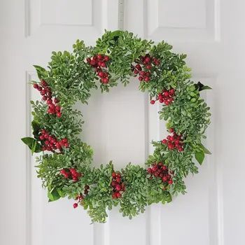 20 inch Christmas wreath made of boxwood greenery and red berries for festive front door decor
