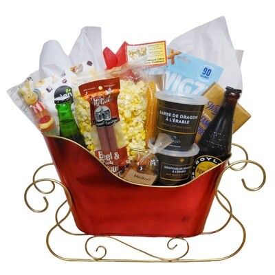 Holiday Treat Basket filled with snacks and sweets arranged in a red metal sleigh with gold runners
