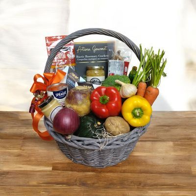 Bountiful Gift Basket filled with fresh vegetables, cheeses, meats, and gourmet foods in a wicker basket
