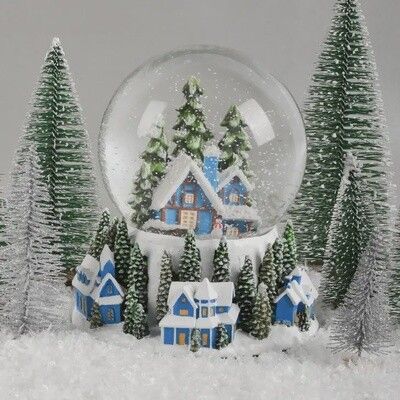 Blue House Christmas snow globe in snowy forest display with trees and winter scene
