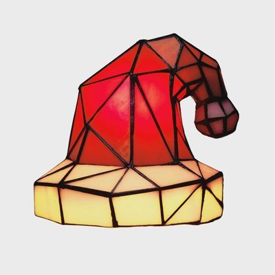 Santa hat stained glass Tiffany lamp on white background showing red and white glass design
