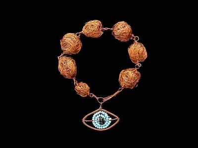Copper bead bracelet with evil eye pendant