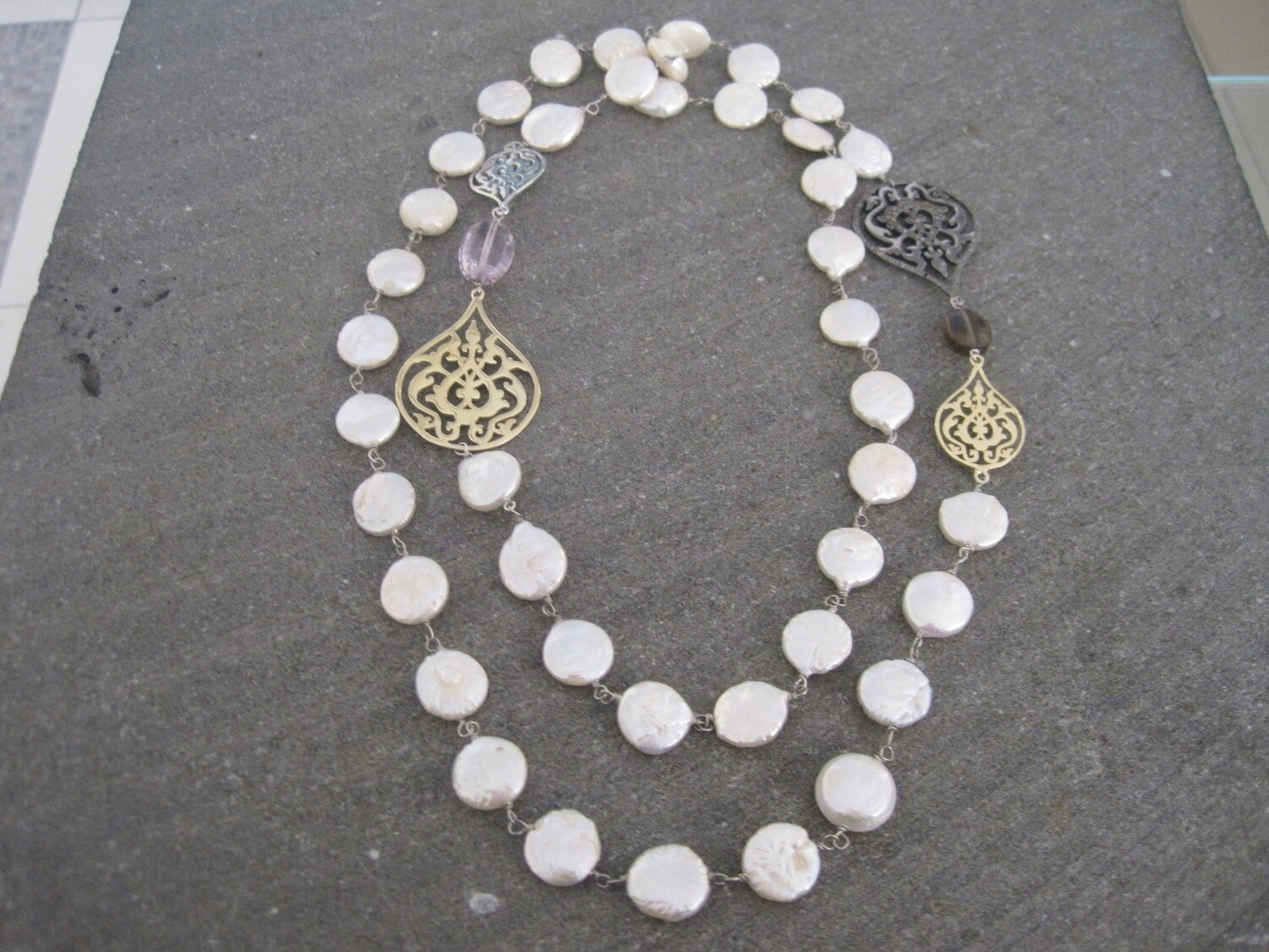 LONG PEARL NECKLACE WITH TWOTONE ARABESQUE MOTIFS