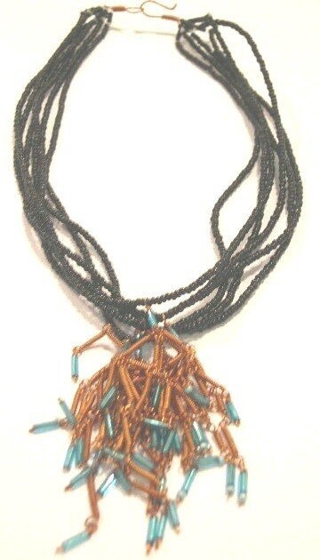 MULTI LAYER BLACK NECKLACE. TURQ TASSEL