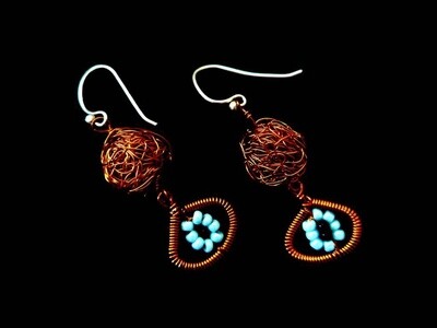 Copper bead earring with evil eye motif