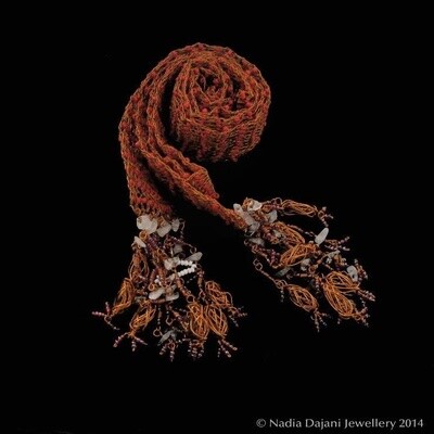 Knitted copper scarf with glass beads and tassels