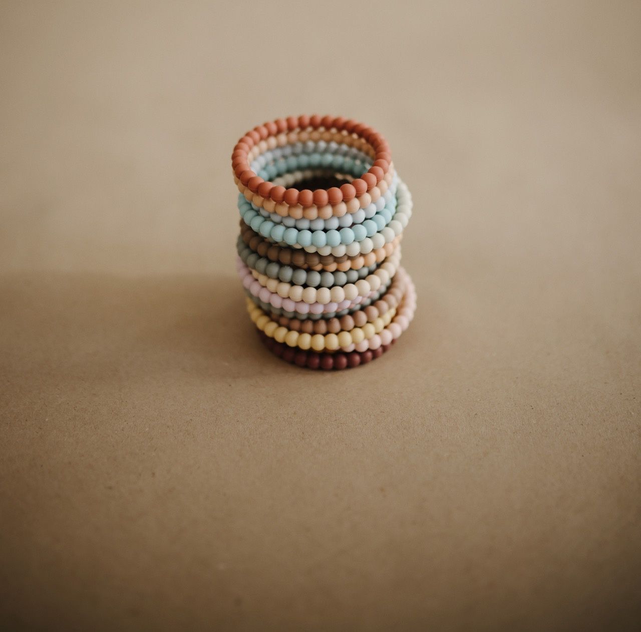 MUSHIE · bijtring armband siliconen (mellow / terracotta / perlw)