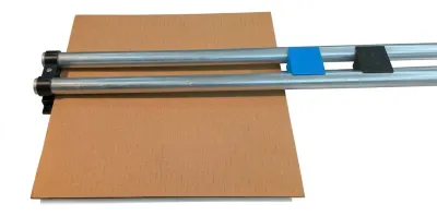 Box maker with corrugated material ready for cutting