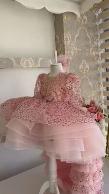 Luxurious baby pink dress with frill trail and headband.