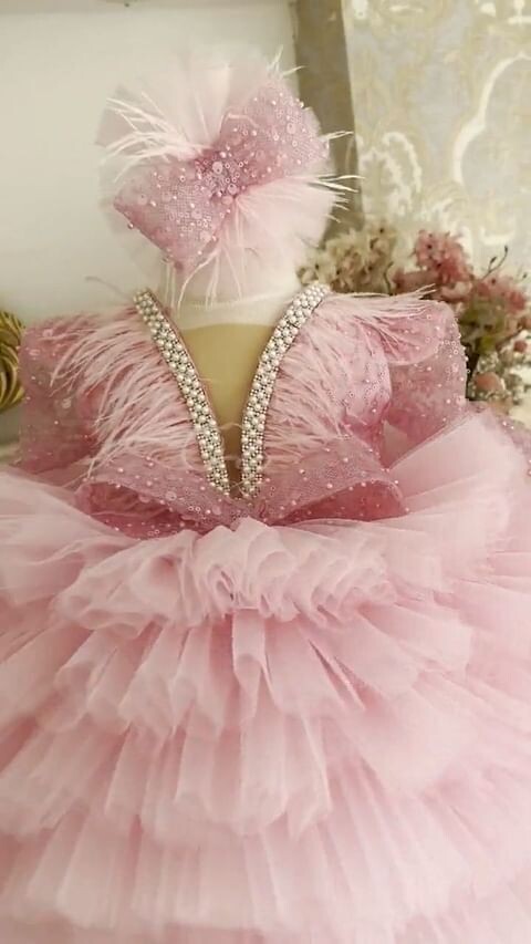 Luxurious pink frill dress with plain trail and headband.