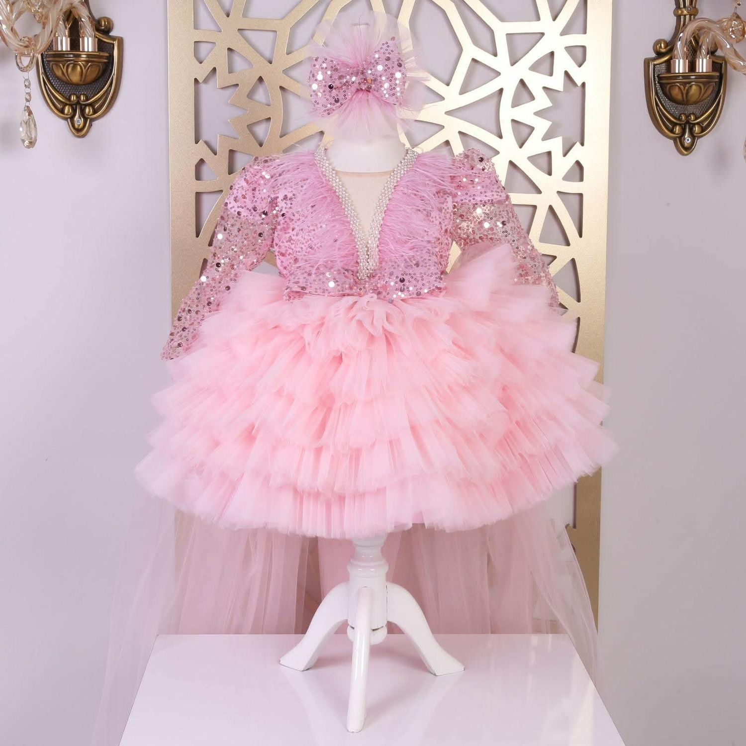 Luxurious pink frill dress with plain trail and headband.