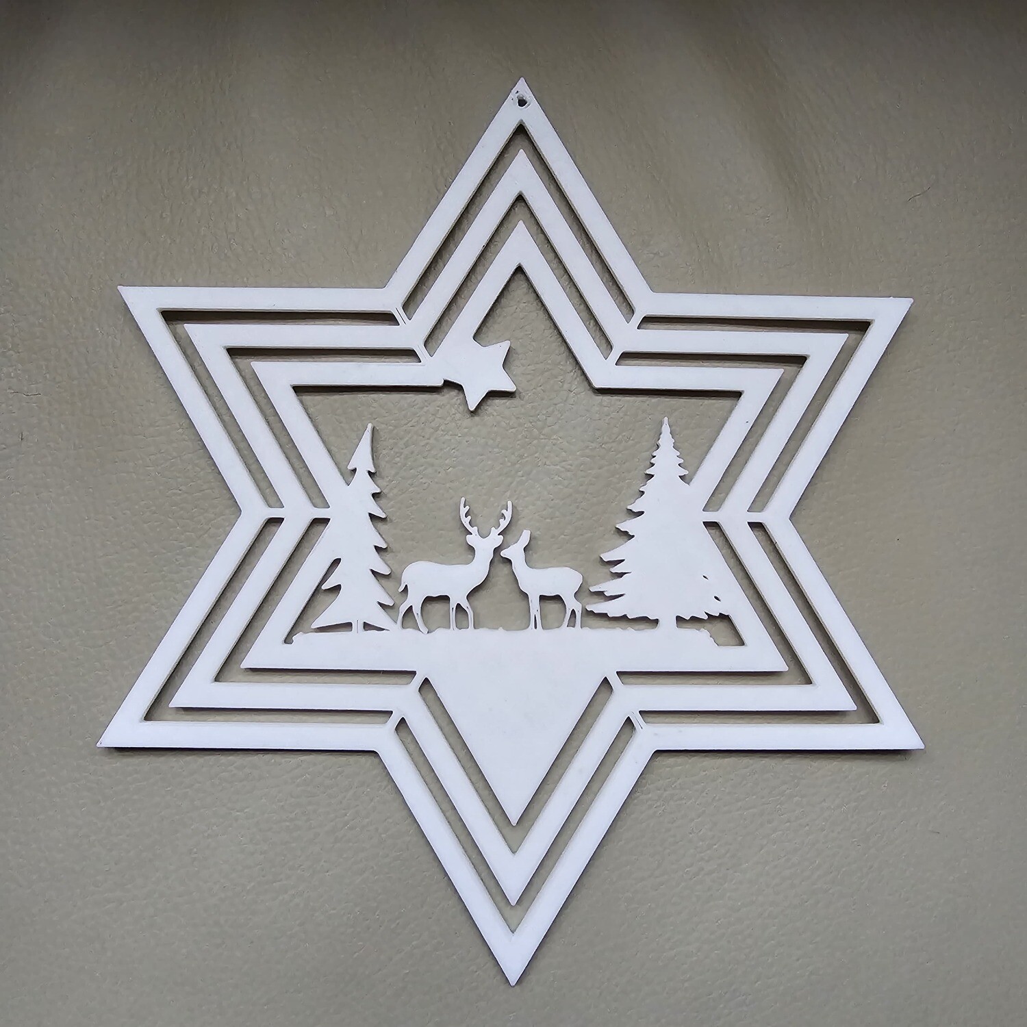 Weihnachtsstern mit Hirschen und Bäumen