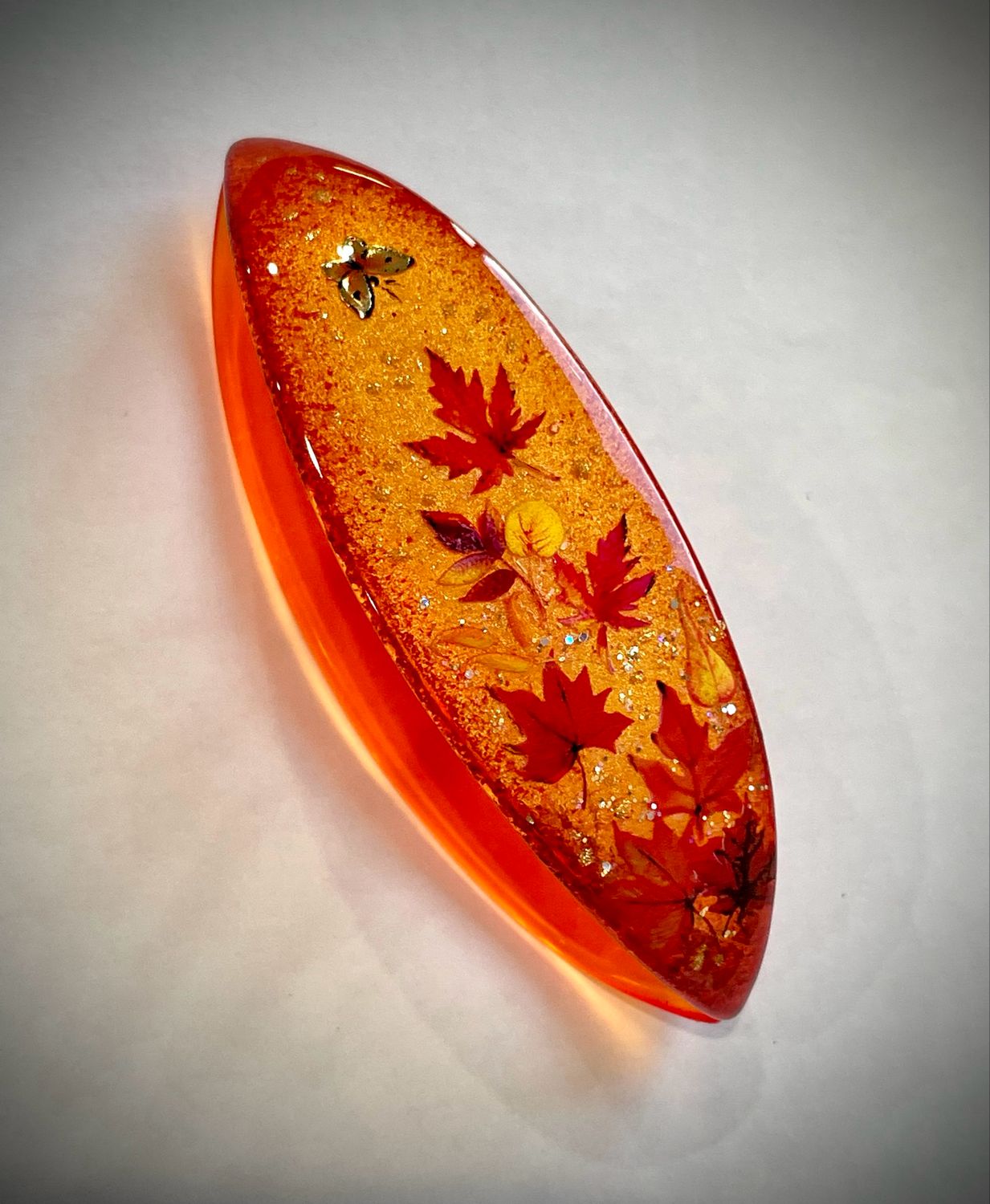 Handmade acrylic shuttle decorated on one side, “Golden Drift”
