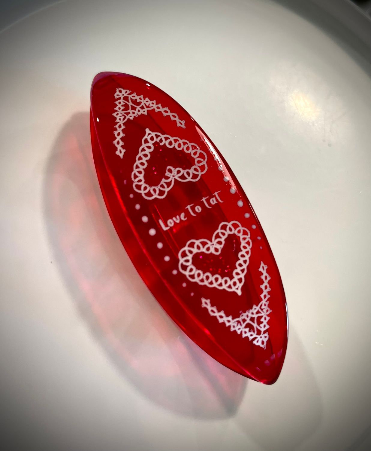 Handmade acrylic shuttle decorated on one side, Love to Tat, ruby red transparent