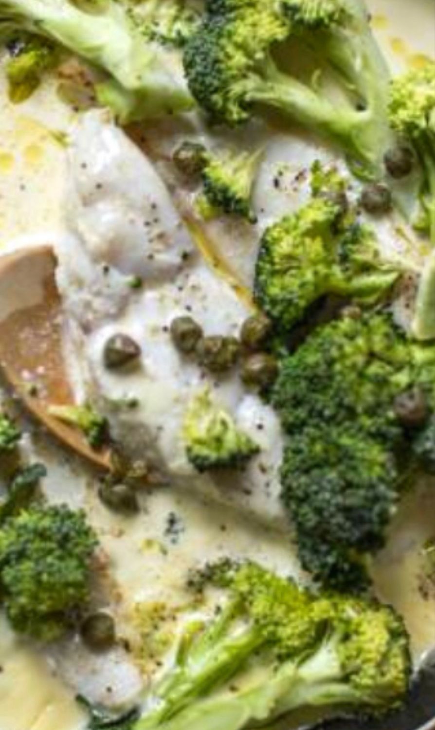 Fresh haddock, gently seared to perfection, finished in a velvety lemon–caper broccoli cream sauce, served with fragrant Spanish yellow rice.