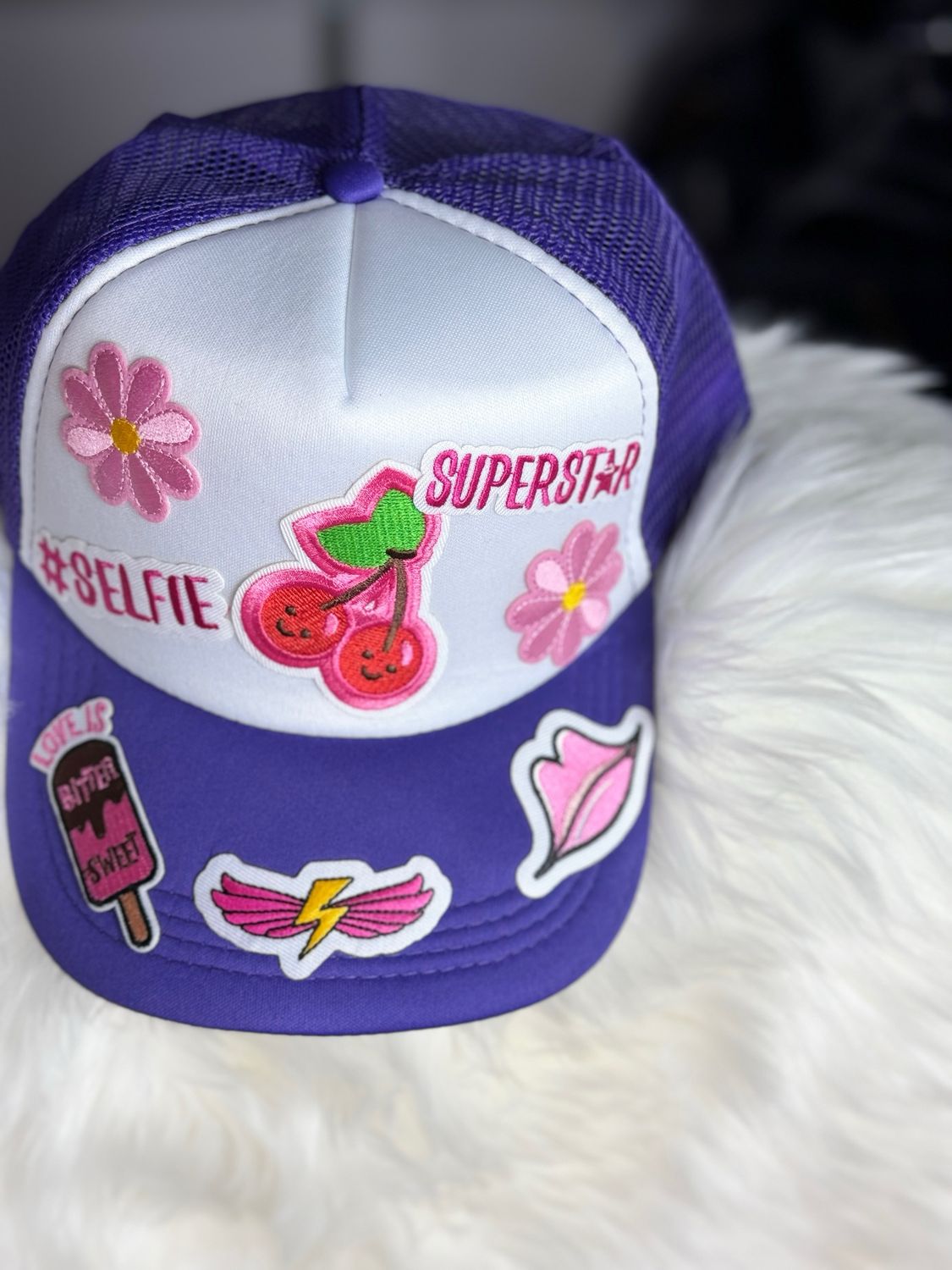 PATCHWORKZ: Soft foam trucker hat with mesh backing and snapback with multiple patches. Themed hat