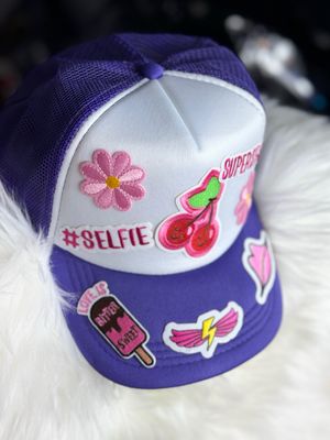 PATCHWORKZ: Soft foam trucker hat with mesh backing and snapback with multiple patches. Themed hat