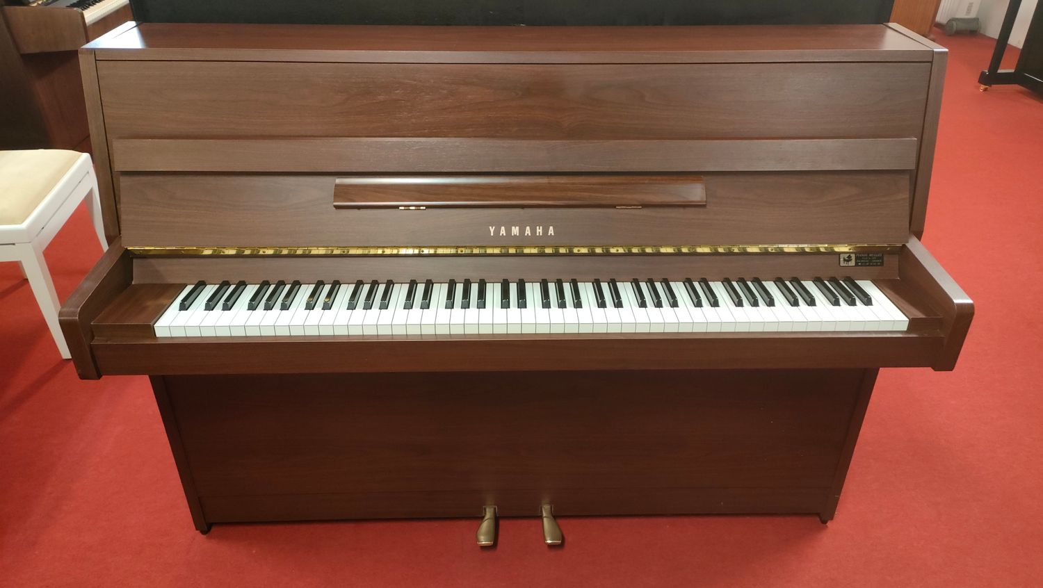 Piano droit Yamaha en bois foncé