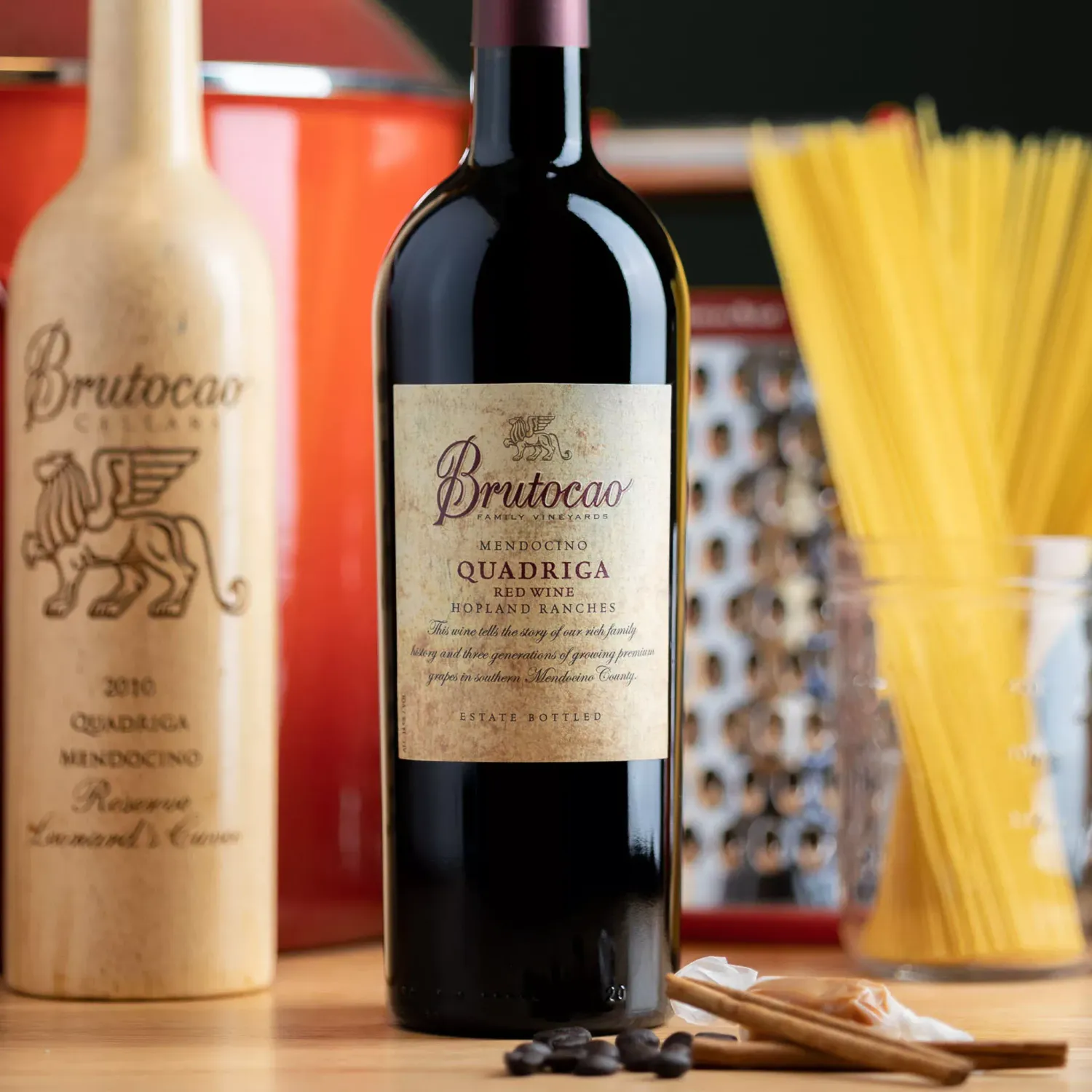 Wine bottles on a table with Pasta sticks in the background