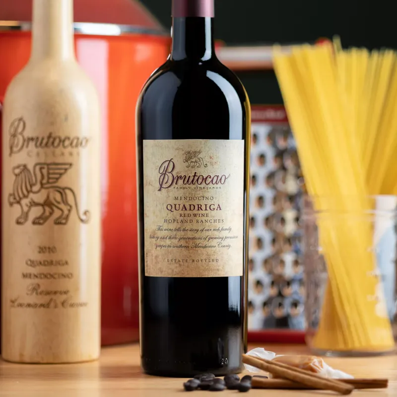 Wine bottles on a table with Pasta sticks in the background