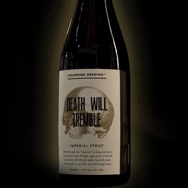 Glass Bottle of Beer with writing on it that reads Death Will Tremble
