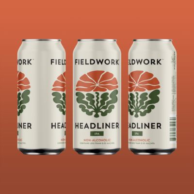 Three cans of beer with brown background with Fieldwork Headliner written on them and artwork in the middle