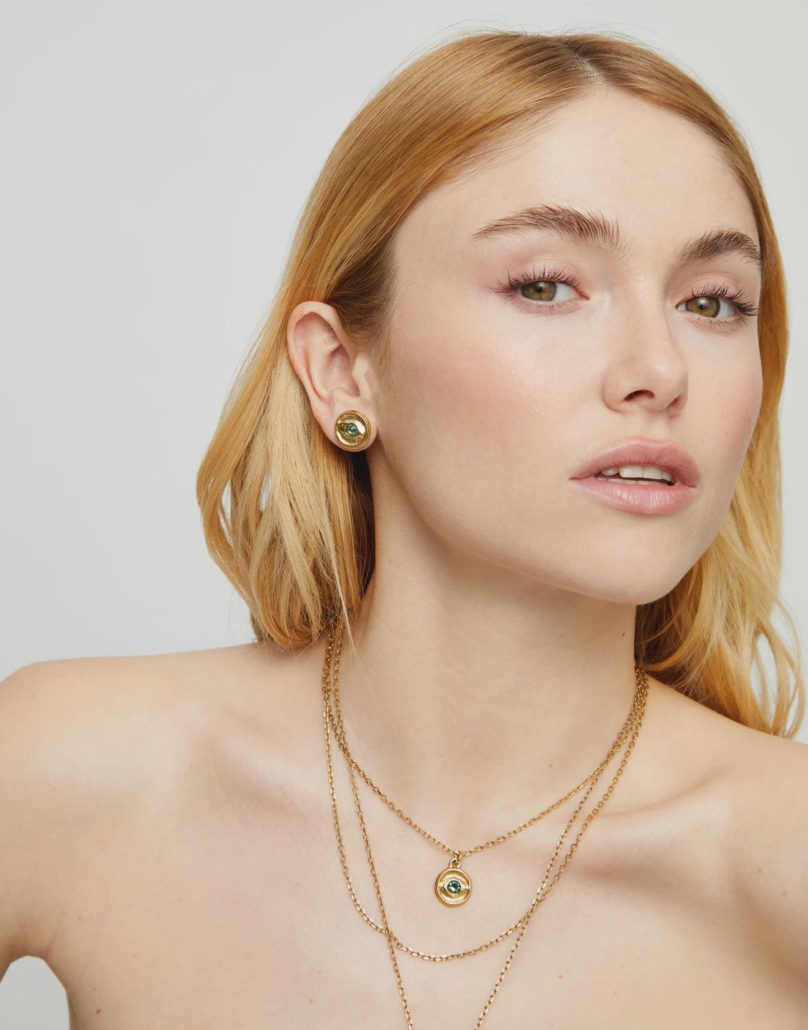 Stud gold earrings with green crystal