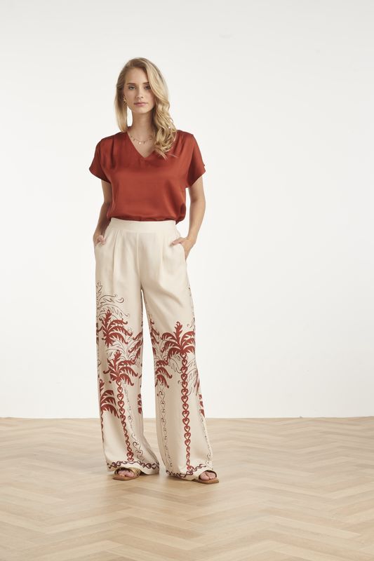 Wide leg trousers with palm tree design in cream with rust brown detail