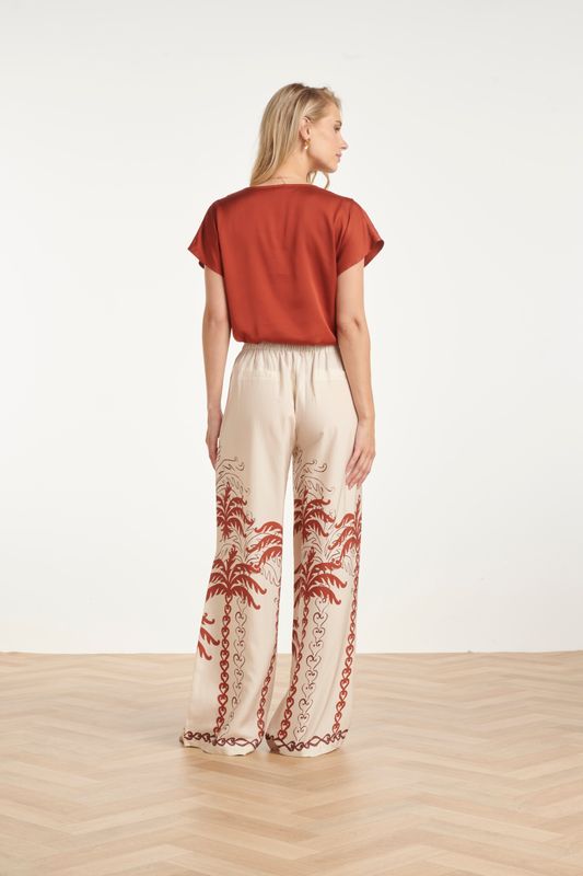 Wide leg trousers with palm tree design in cream with rust brown detail