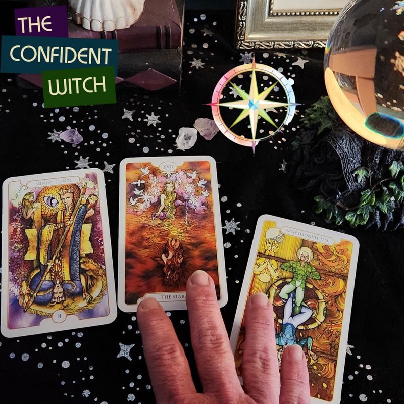 Hand selecting Tarot cards on a starry altar with crystal ball and compass, overlaid text reading The Confident Witch.