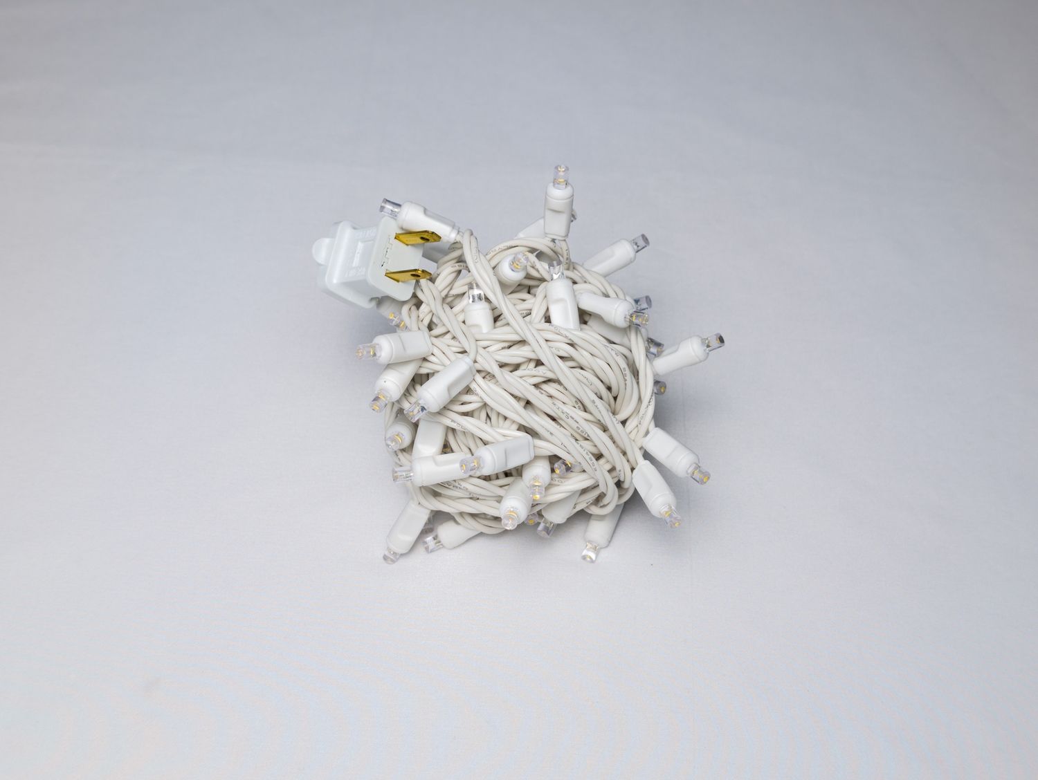 Mini Lights Warm White with 4-inch spacing, 70 lights on white wire for professional residential and commercial decorative installations.