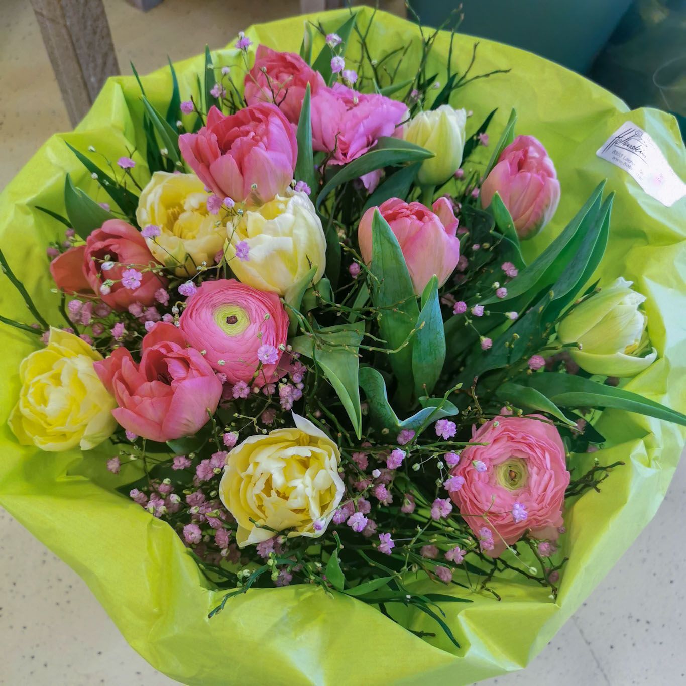 Tulpen und Ranunkeln-Strauss in Papiermanchette, bunt gemischte Farben Tulpen und Ranunkeln-Strauss in Papiermanchette, bunt gemischte Farben