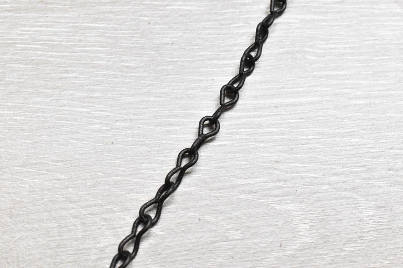 10 ft decorative #16 black powder coated chain shown coiled on surface, rated for 10 lb max load, ideal for indoor or outdoor