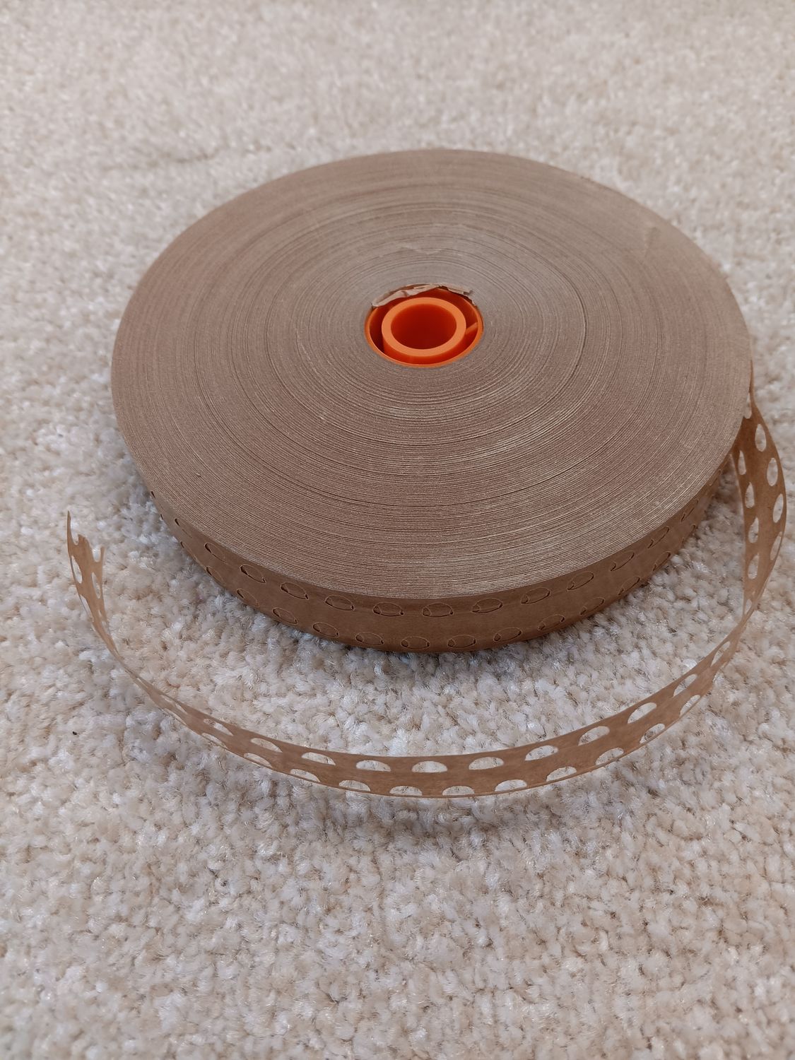 The PT2 Gummed Paper Veneer Tape is a high-quality, perforated tape with strategically placed holes for optimal air release, reducing bubbling and ensuring a smooth, professional finish.