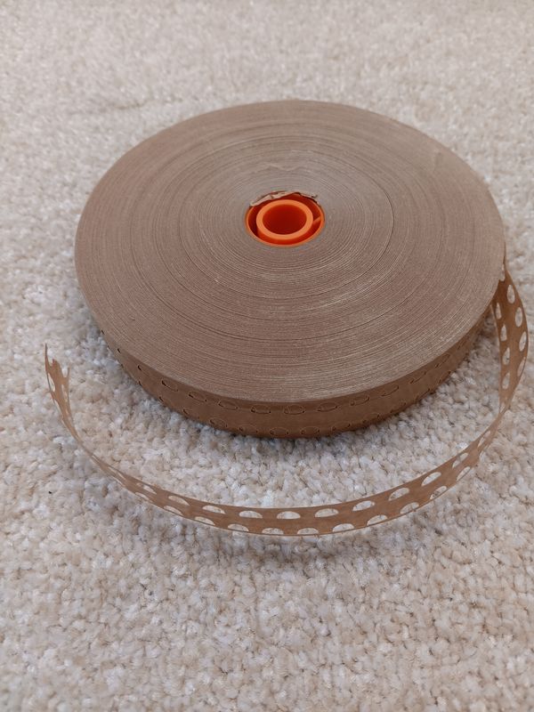 The PT2 Gummed Paper Veneer Tape is a high-quality, perforated tape with strategically placed holes for optimal air release, reducing bubbling and ensuring a smooth, professional finish.