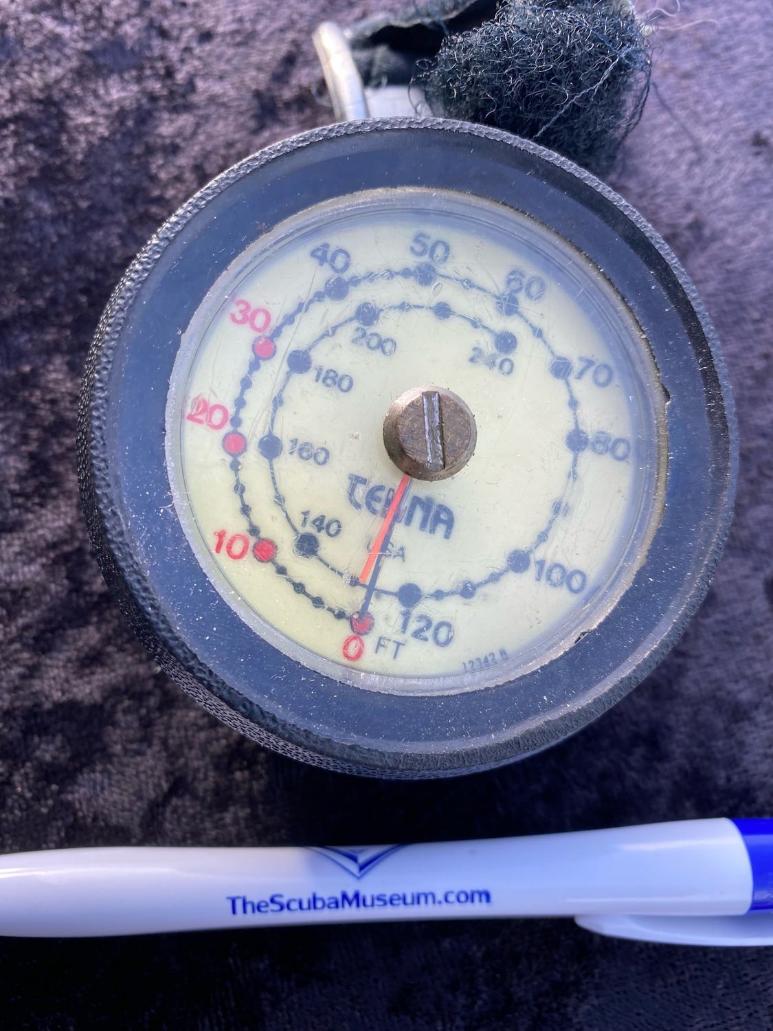 Tekna wrist depth gauge with max depth indicator needle.