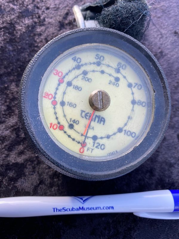 Tekna wrist depth gauge with max depth indicator needle.