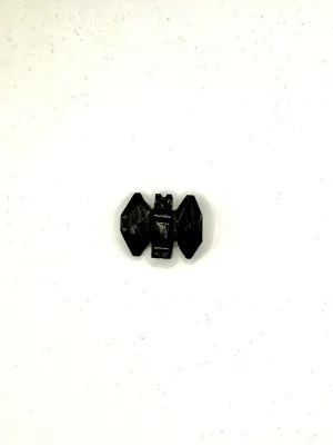 Black onyx bat carving with faceted wings spread, on a white surface.