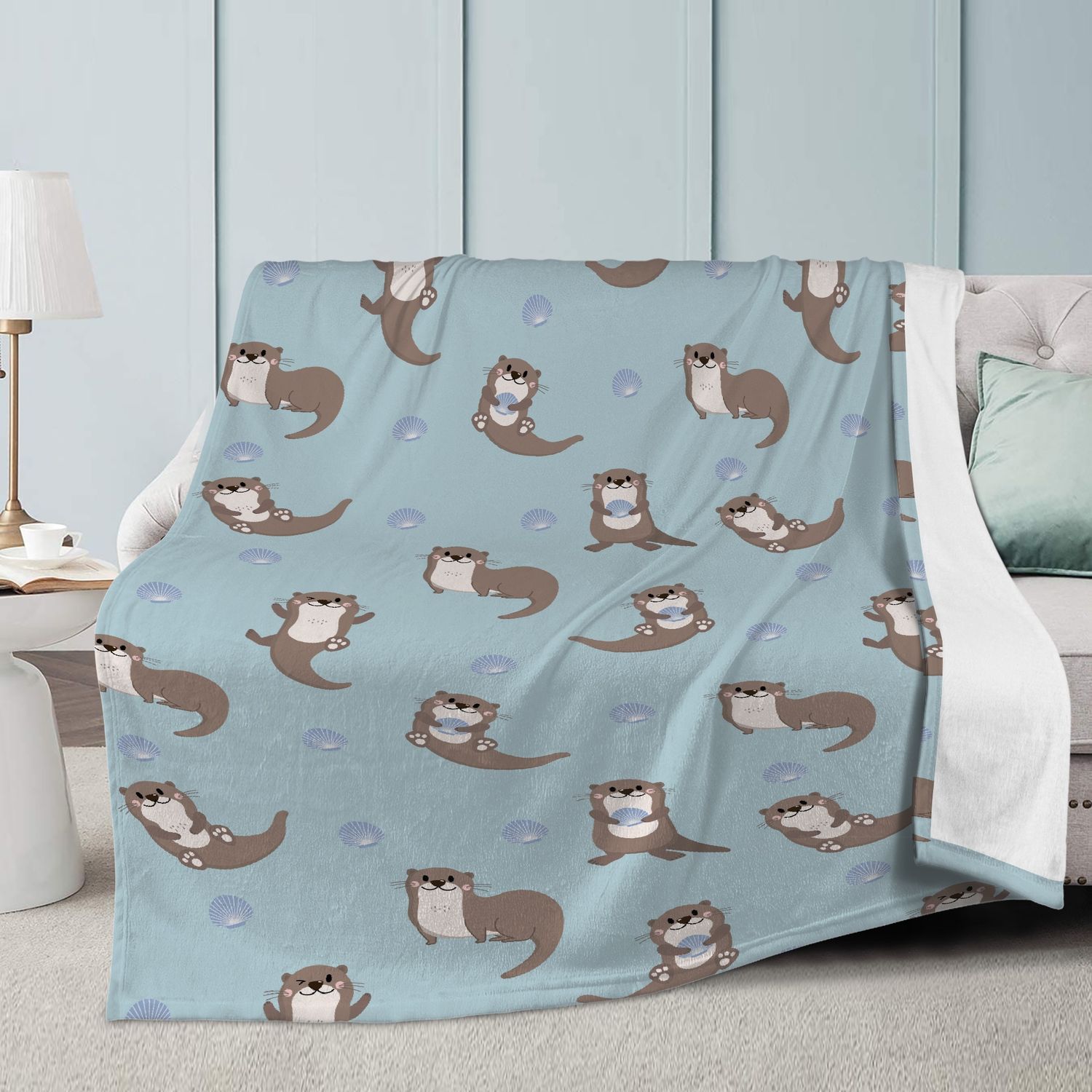 Light blue cuddly blanket with cute otters