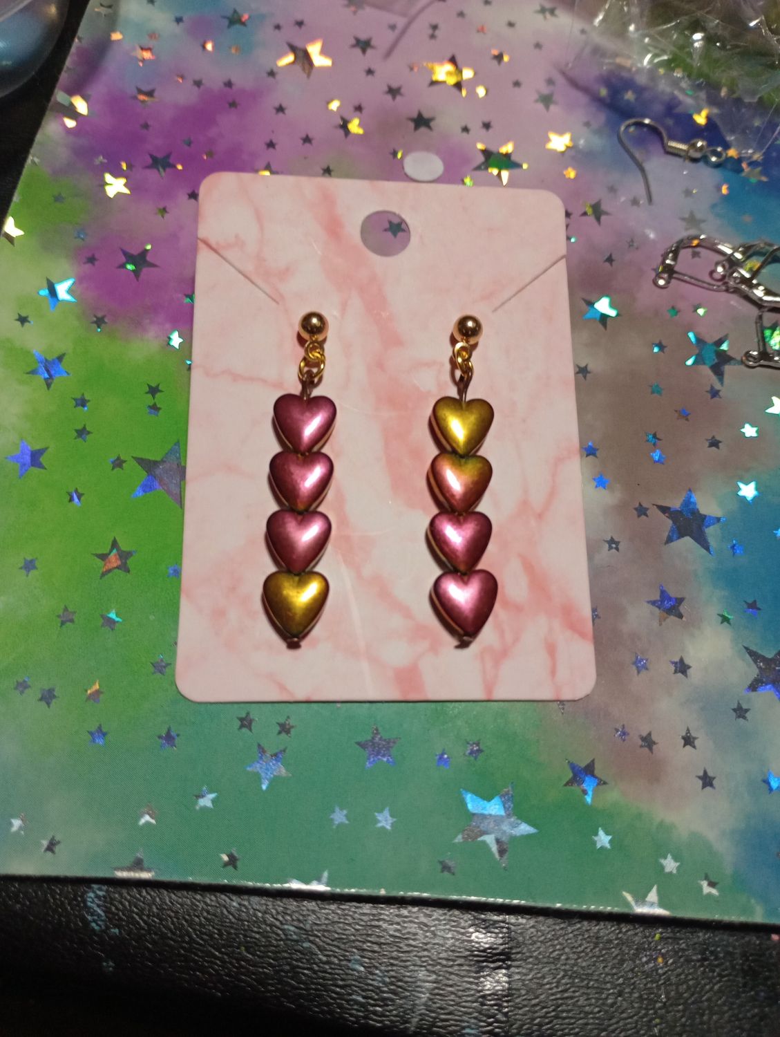 Hematite heart earrings (Rainbow Aura coated)