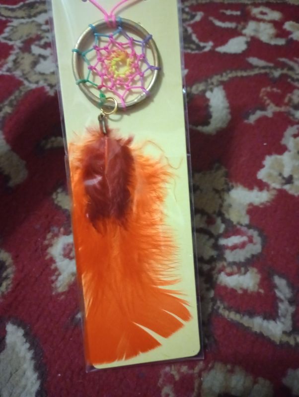 Dreamcatcher, gold with red and orange, represents grounding