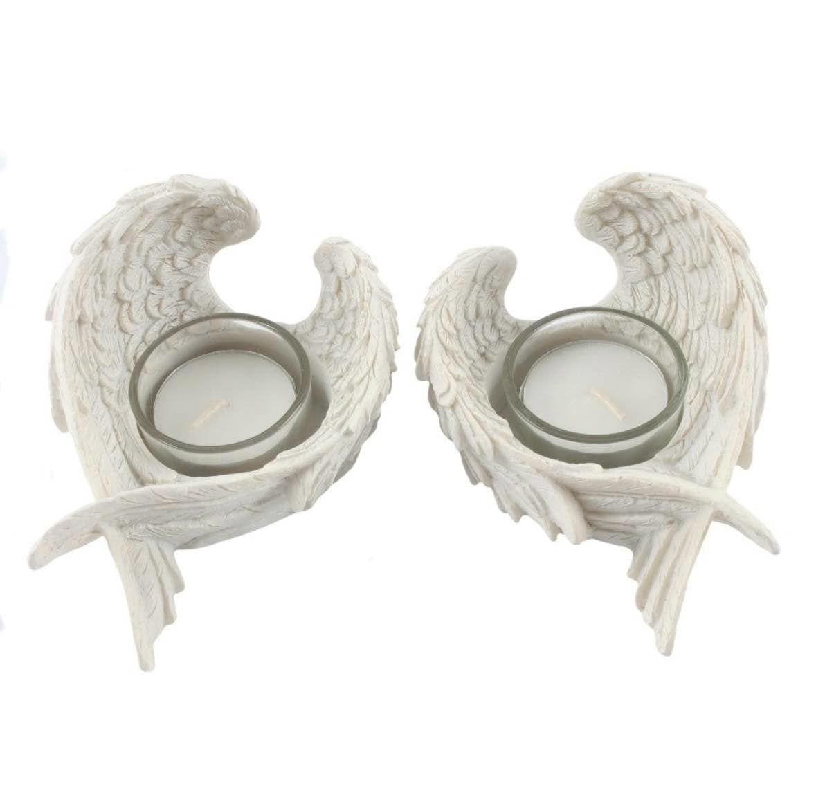 A box of two white resin angel wing tealight holders. These items would look great on a mantle or tabletop. A great little addition to your homeware and would also make a great gift