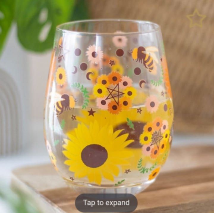 Raise a glass to the Summer Solstice with this beautiful stemless glass, featuring a vibrant design of sunflowers, buzzing bees, mystical pentagrams and moon phases. A delightful way to toast to the l