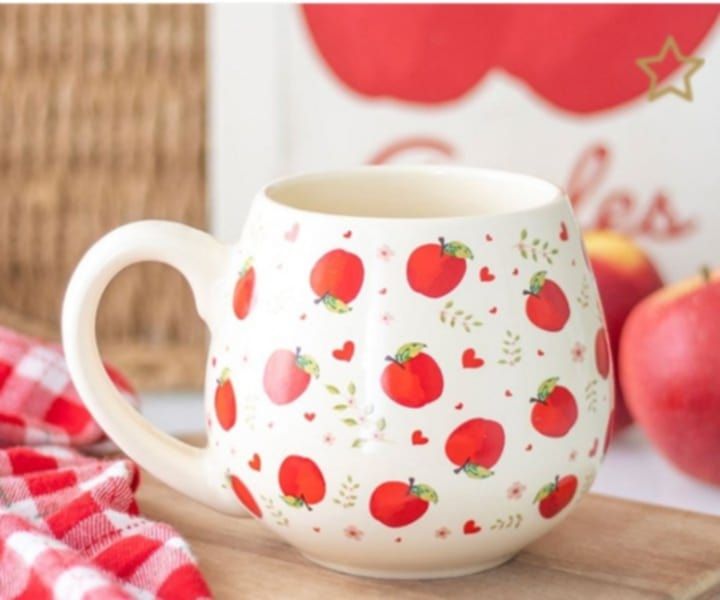 Enjoy your favourite hot drink in this charming ceramic mug, decorated with a playful apple print perfect for adding a splash of countryside style to your day. Great for cosy mornings at home or as a
